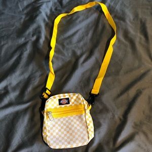 Small white and yellow Dickie’s shoulder bag with front pocket.